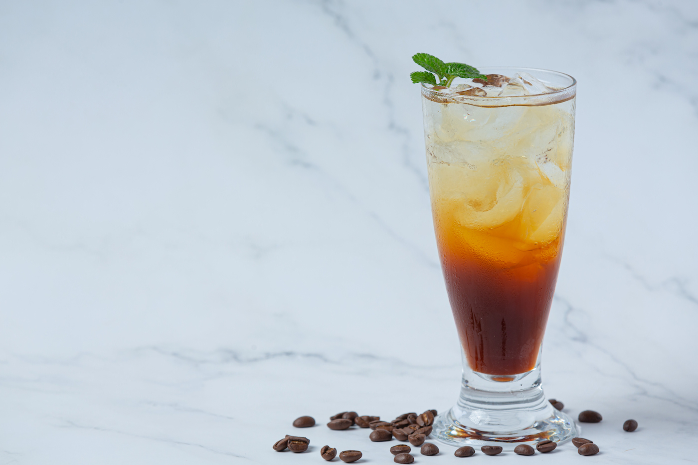 Summer drink iced coffee or soda in a glass on the white background.